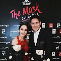 a man and woman posing for a photo with teddy bears