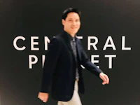 a man walking in front of a sign that says central park