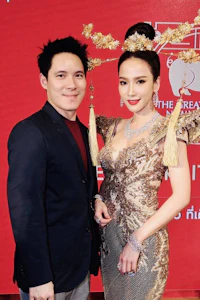 a man and woman posing for a photo on a red carpet