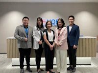 a group of people posing for a photo in an office