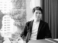 a man sitting at a desk in front of a window