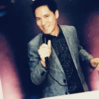 a man in a suit is holding a microphone