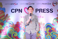 a man holding a microphone in front of a colorful background