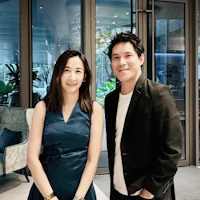 a man and woman posing for a picture in a hotel lobby